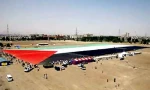 Largest ever Palestinian flag rolled