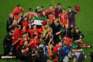 Morocco players celebrate with Palestinian flag after Spain upset